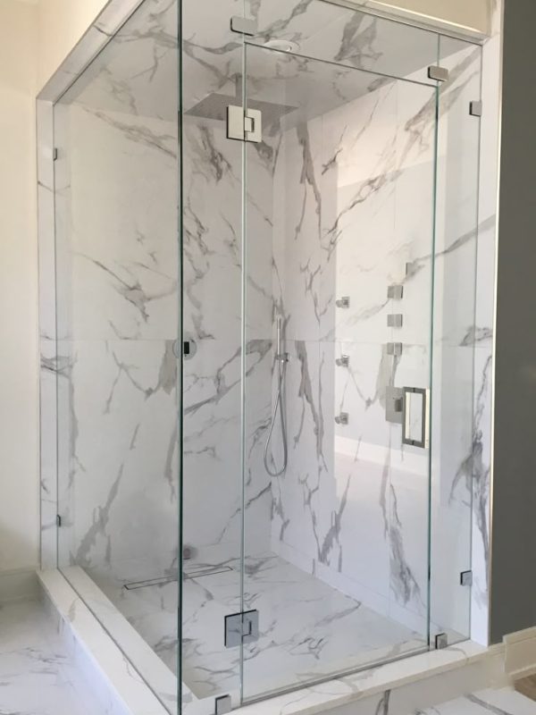 Frameless clear glass shower enclosure, door, 2 inline panels, transom and return panel